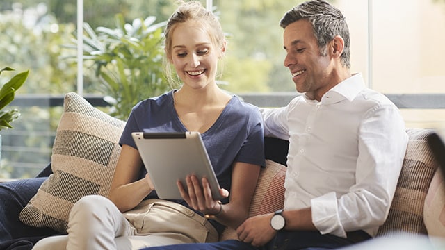 couple making a purchase on a tablet